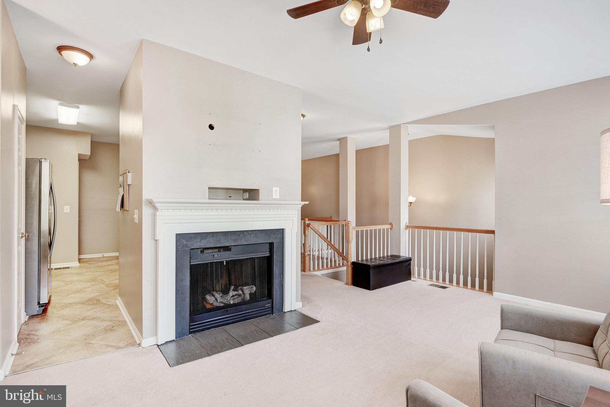 13017 Bath Gate Way Bristow, VA 20136 - Photo 8 of 35 a living room with furniture and a fireplace
