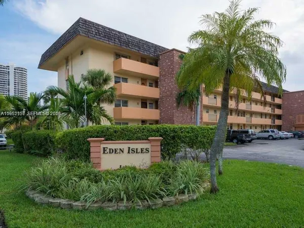 a front view of multi story residential apartment building with yard and green space