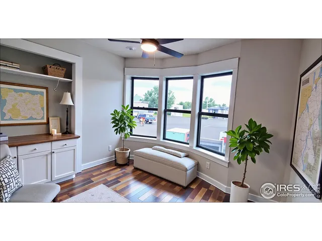 a living room with furniture potted plant and a flat screen tv
