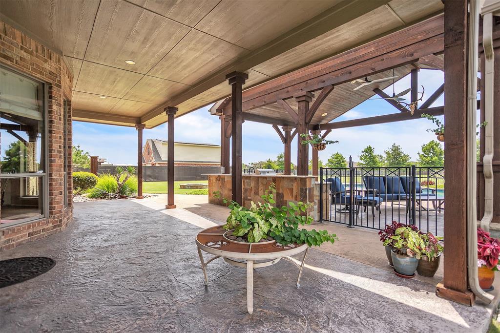 12286 Emerald Ranch Lane North Forney, TX 75126 - Photo 32 of 40 a view of a porch with furniture and a garden