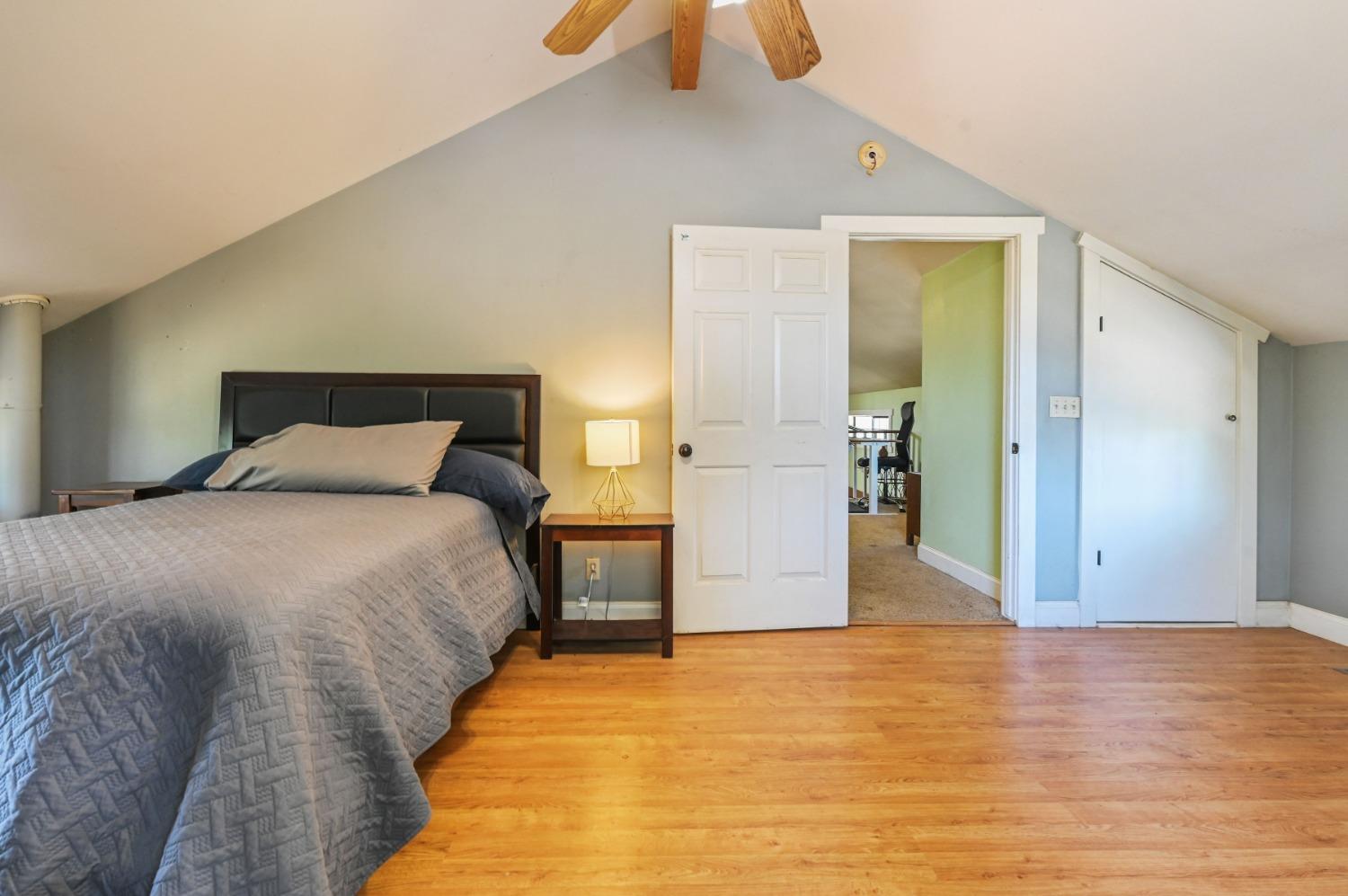 6640 Railroad Flat Road Mountain Ranch, CA 95246 - Photo 29 of 60 a bedroom with a bed and wooden floor