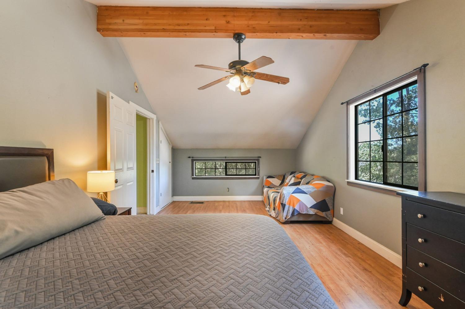 6640 Railroad Flat Road Mountain Ranch, CA 95246 - Photo 31 of 60 a bedroom with a bed and a chandelier