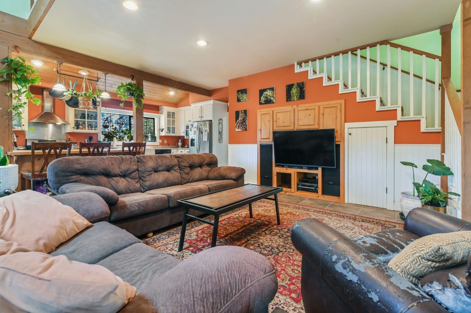 6640 Railroad Flat Road Mountain Ranch, CA 95246 - Photo 9 of 60 a living room with furniture a fireplace and a floor to ceiling window