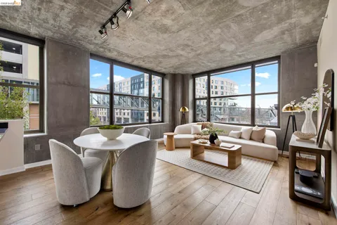 a living room with furniture flowerpot and wooden floor