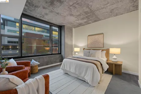a view of kitchen with kitchen island a large window cabinets and stainless steel appliances