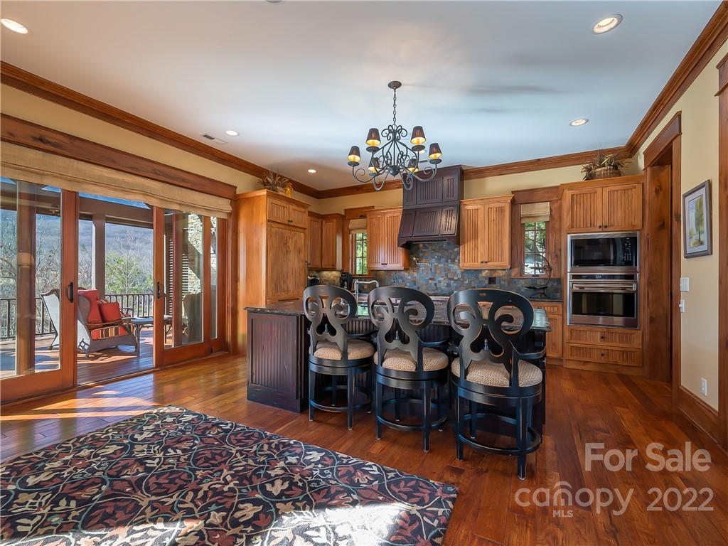538 Chestertown Drive Mill Spring, NC 28756 - Photo 11 of 46 a view of a dining room with furniture window and wooden floor
