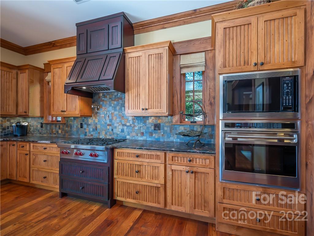 538 Chestertown Drive Mill Spring, NC 28756 - Photo 15 of 46 a kitchen with granite countertop wooden cabinets stainless steel appliances and a window