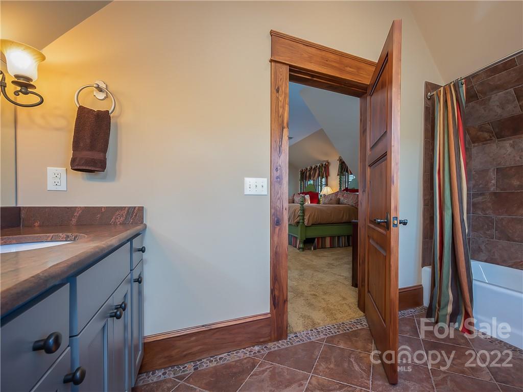 538 Chestertown Drive Mill Spring, NC 28756 - Photo 19 of 46 a en suite bathroom with a sink and a mirror