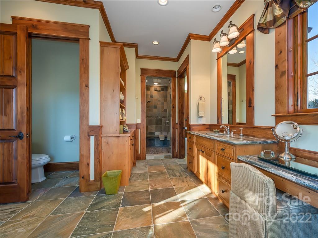 538 Chestertown Drive Mill Spring, NC 28756 - Photo 28 of 46 a bathroom with a tub a sink and a large mirror