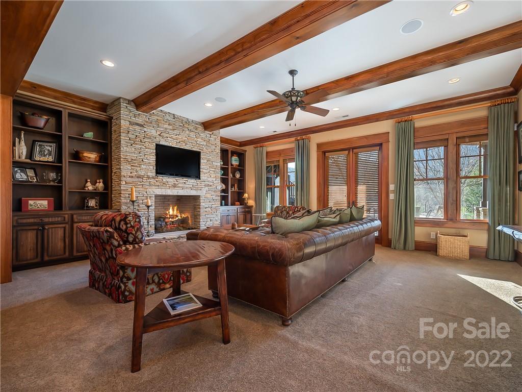 538 Chestertown Drive Mill Spring, NC 28756 - Photo 30 of 46 a living room with furniture a fireplace and a flat screen tv