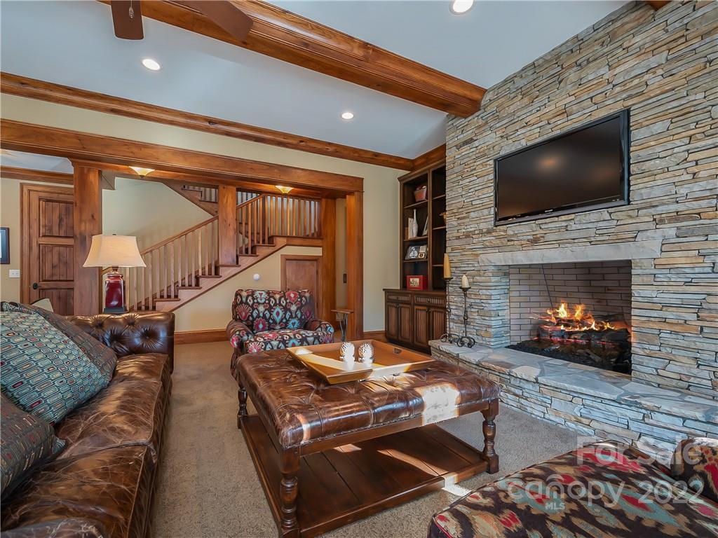 538 Chestertown Drive Mill Spring, NC 28756 - Photo 31 of 46 a living room with furniture a flat screen tv and a fireplace