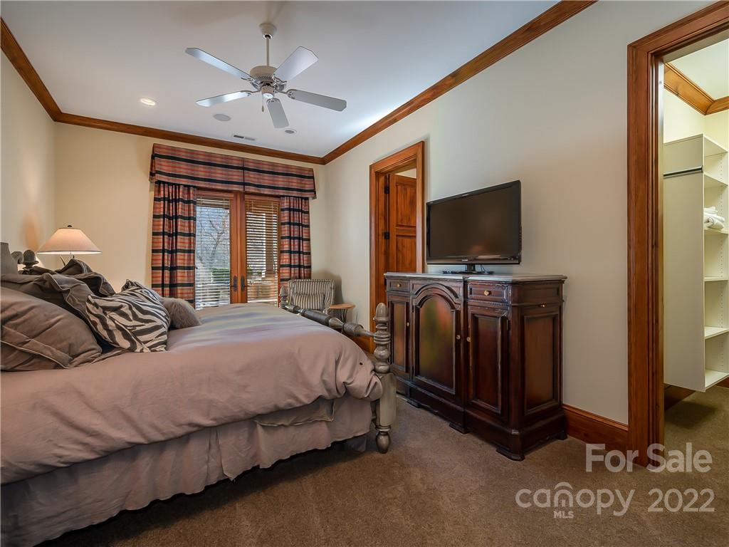 538 Chestertown Drive Mill Spring, NC 28756 - Photo 34 of 46 a spacious bedroom with a bed and a flat screen tv