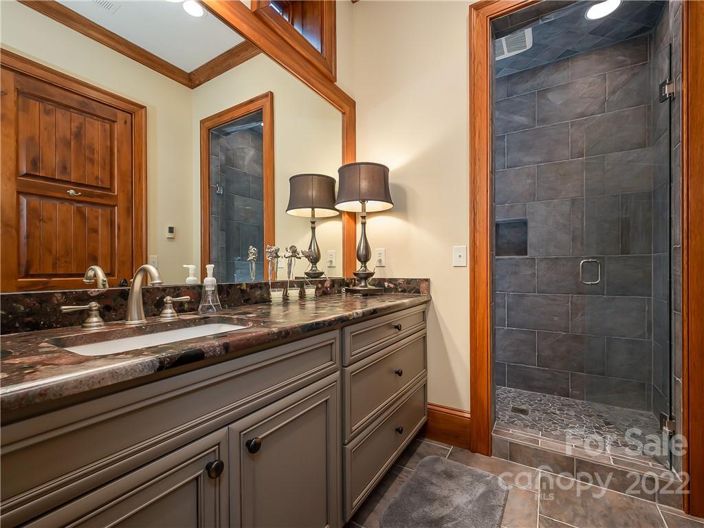 538 Chestertown Drive Mill Spring, NC 28756 - Photo 35 of 46 a bathroom with a double vanity sink and a mirror