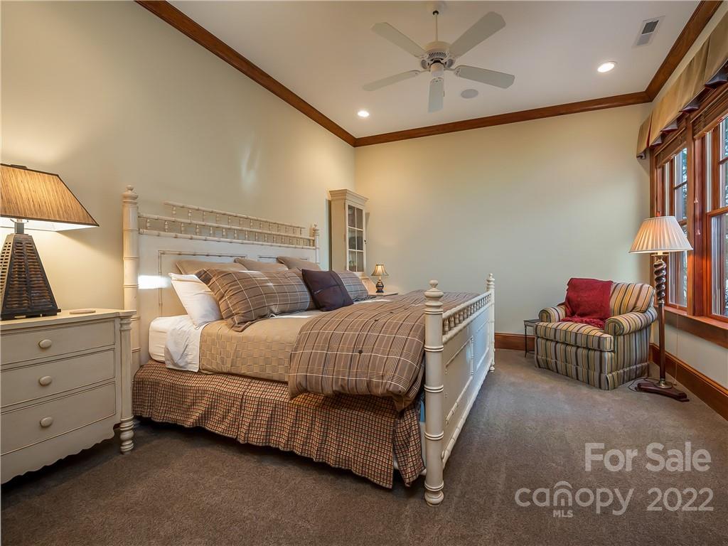 538 Chestertown Drive Mill Spring, NC 28756 - Photo 39 of 46 a bedroom with bed and a chandelier