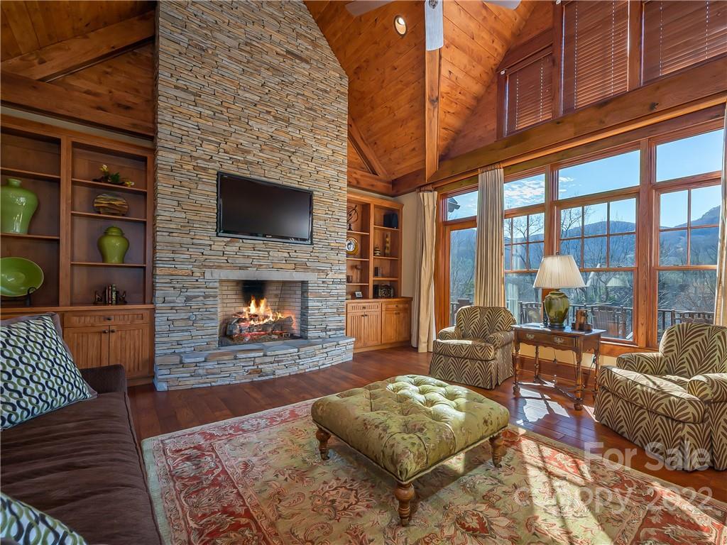 538 Chestertown Drive Mill Spring, NC 28756 - Photo 9 of 46 a living room with furniture a fireplace and a floor to ceiling window