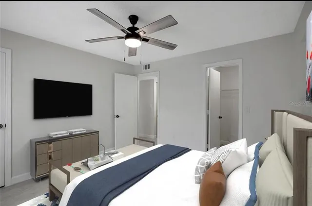 a bedroom with a bed and a flat screen tv