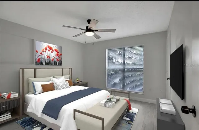 a bedroom with a bed and a flat screen tv