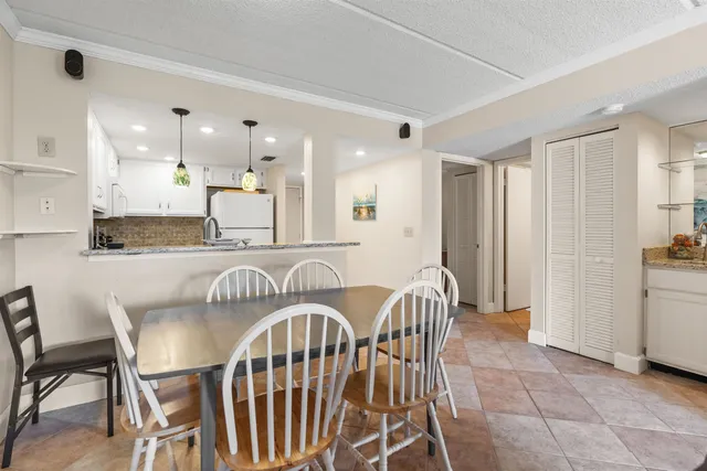 a view of a a dining room and livingroom with furniture