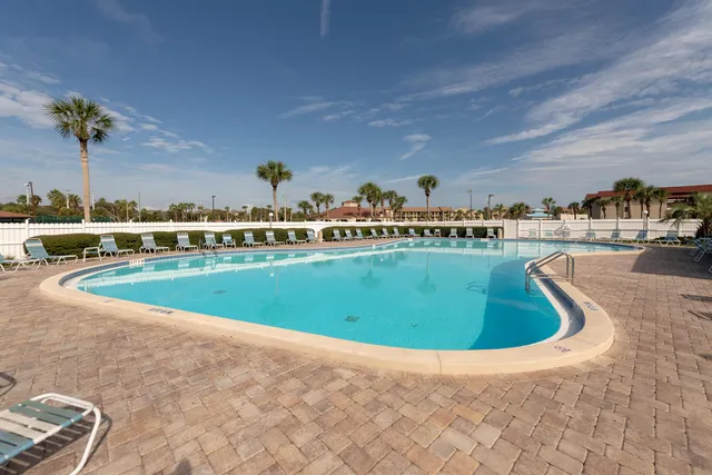 a view of a swimming pool with a yard