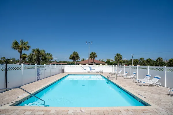 a view of a swimming pool and an outdoor seating