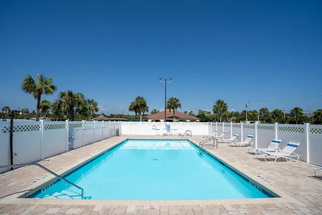 a view of a swimming pool and an outdoor seating