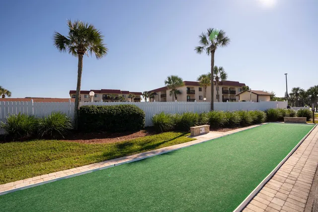 a view of a house with a yard and potted plants