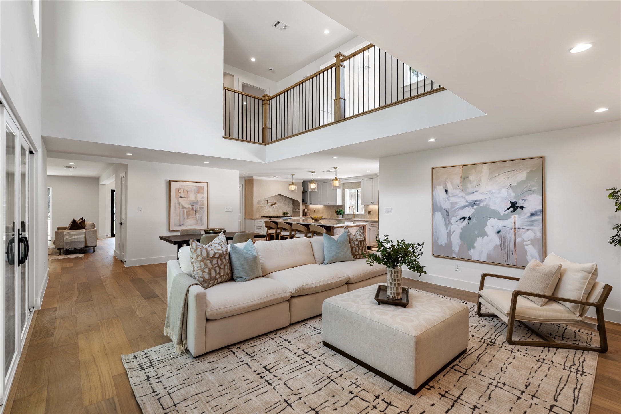 Spacious family room featuring double-height ceilings and open flow to the kitchen