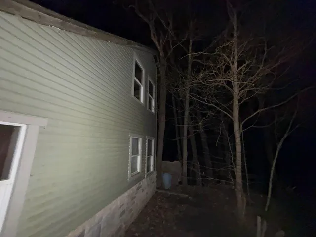 a view of a house with a small yard and furniture