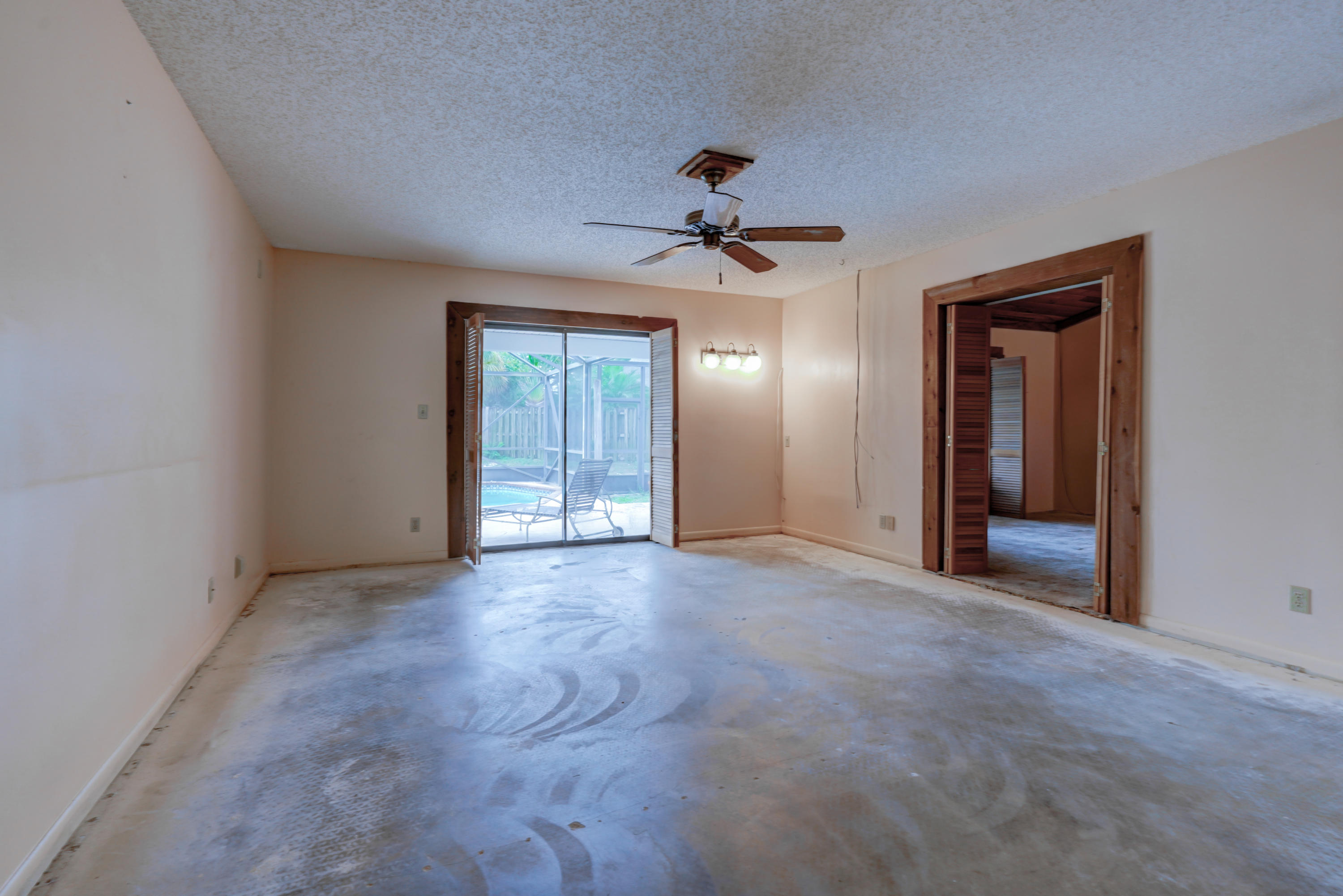 1300 Southwest 2nd Street Boca Raton, FL 33486 - Photo 15 of 18 a view of a hallway with a chandelier fan and windows