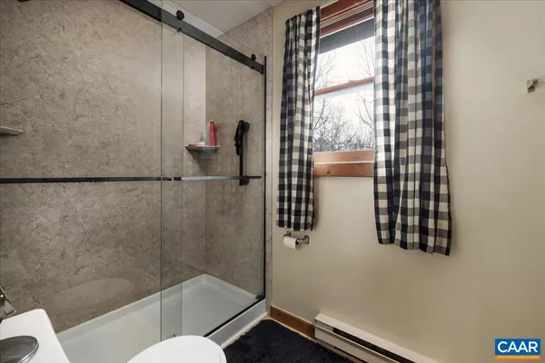 a view of a house with a large tree and a yard