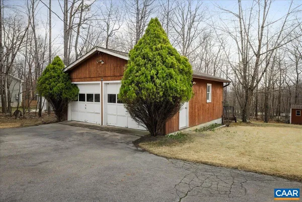 a view of a house with a yard covered in snow