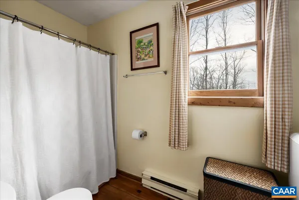 a view of a room with window and wooden floor