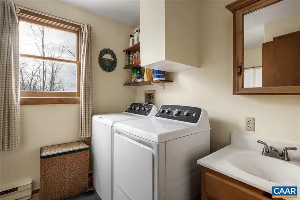 a kitchen with stainless steel appliances a stove a sink cabinets and a window