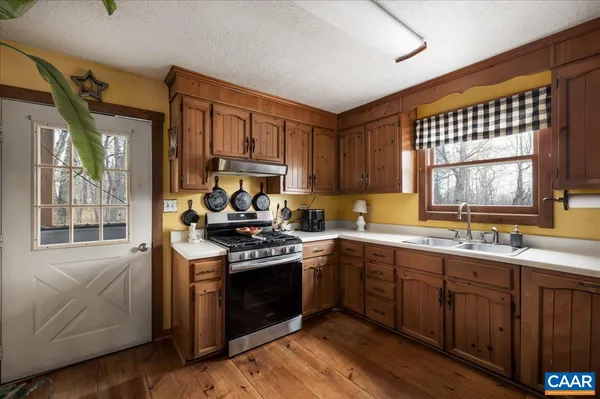 a kitchen with stainless steel appliances a refrigerator sink and cabinets