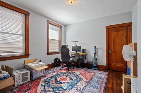 a living room with furniture a rug and a window