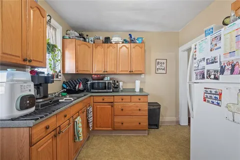 a kitchen with stainless steel appliances a sink window and cabinets
