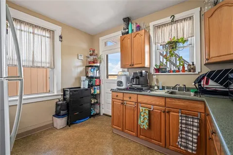 a kitchen with a refrigerator and a sink