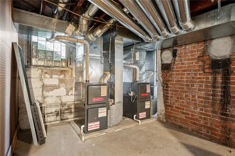 a view of a white house with large windows and a tree