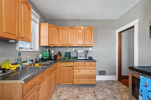 a kitchen with stainless steel appliances granite countertop a sink stove and cabinets