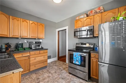 a kitchen with stainless steel appliances granite countertop a stove a refrigerator and a microwave