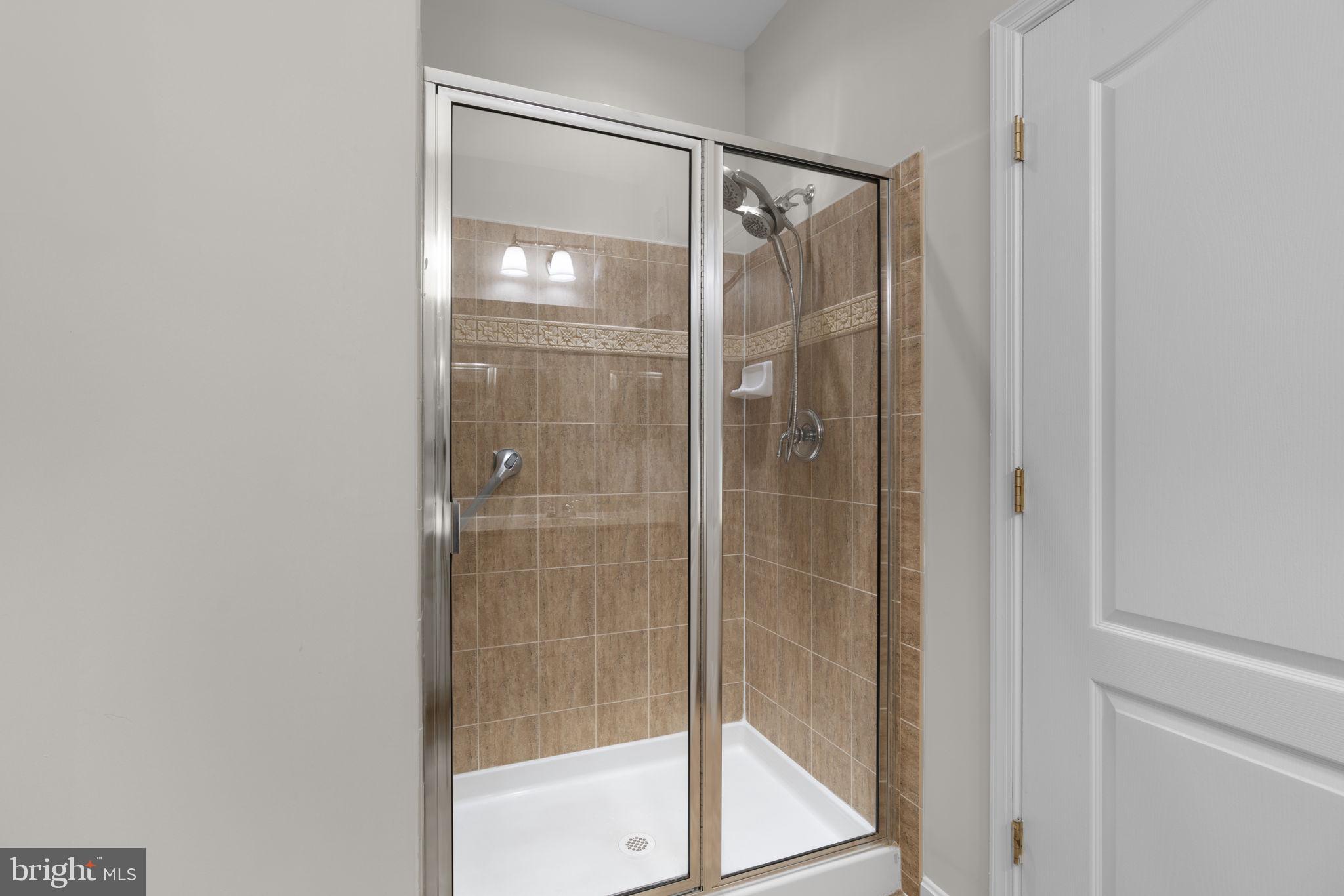 7315 Maplecrest Road, Unit 104 Elkridge, MD 21075 - Photo 35 of 58 a bathroom with a glass shower door