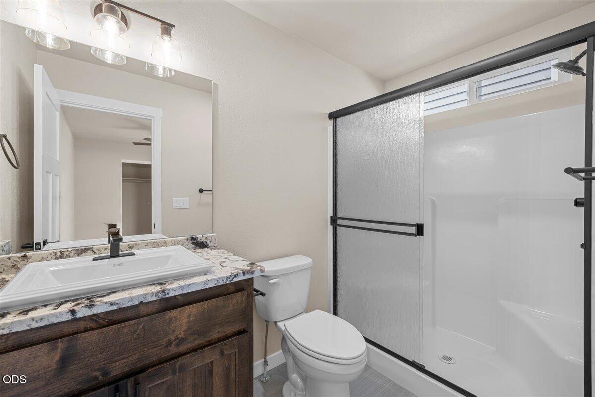 7869 Houston Loop White City, OR 97503 - Photo 5 of 15 a bathroom with a granite countertop sink toilet and shower