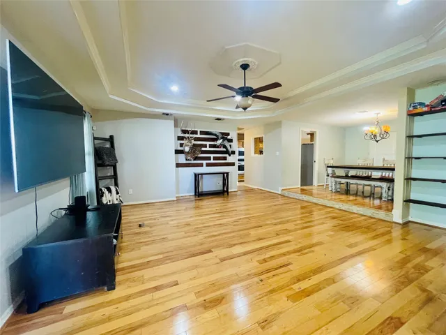 a large room with wooden floor and furniture