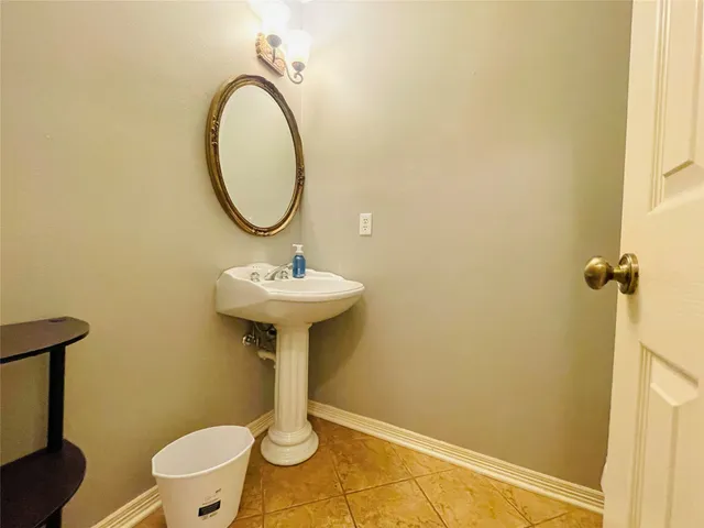 a bathroom with a sink toilet and a mirror