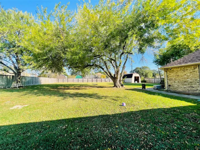 a view of a swimming pool with lawn chairs and plants
