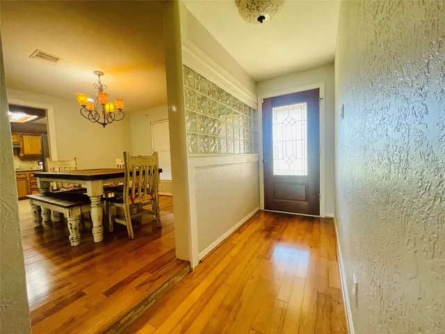 a view of a living room hardwood floor and dining room