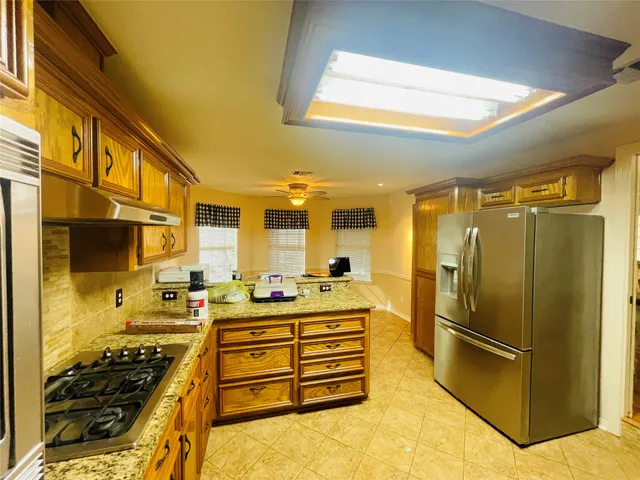 a kitchen with stainless steel appliances a stove and a refrigerator