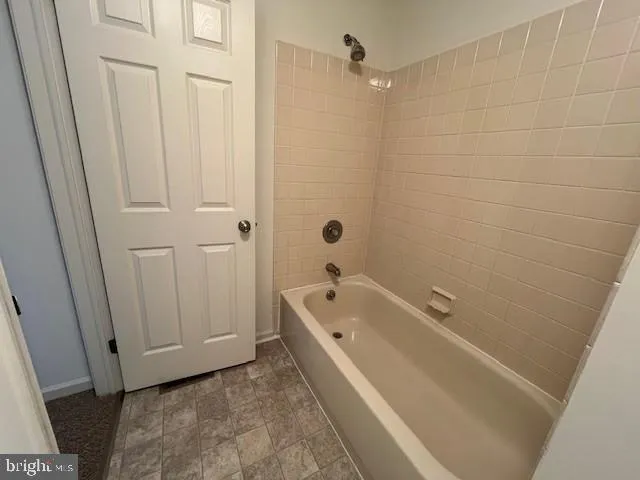 a spacious bathroom with a tub a sink and a shower