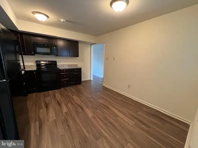 a kitchen with stainless steel appliances a refrigerator and a microwave