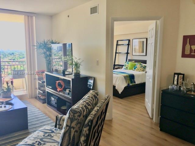 3232 Southwest 22nd Terrace, Unit 1303 Miami, FL 33145 - Photo 15 of 43 a living room with furniture and a wooden floor